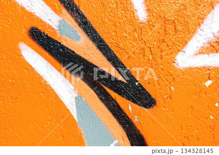 Bold Urban Graffiti Art with Black and White Lines on Vibrant Orange Background 134328145