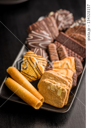 Christmas sweet and cookies on plate on black table. 134328157