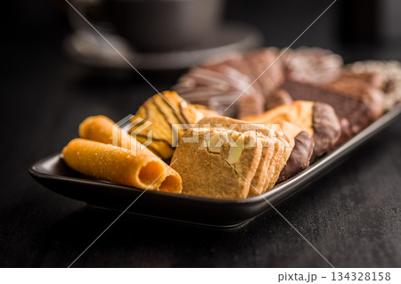 Christmas sweet and cookies on plate on black table. Christmas sweet and cookies on plate on black table. 134328158