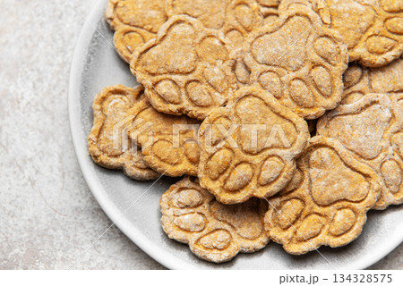 Homemade paw print dog treats on a plate Homemade paw print dog treats on a plate 134328575