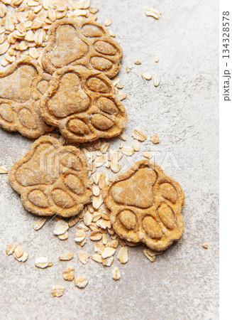 Homemade oat dog treats shaped as paw prints Homemade oat dog treats shaped as paw prints 134328578