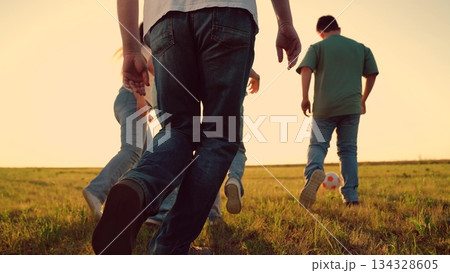 Parents run with child kid playing football green lawn, children kicking ball, mother father girl boy happy family sunset, simple happiness., love, connection., lifestyle, parenting tips, health 134328605