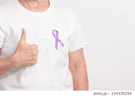Elderly woman with light Purple Ribbon for All cancer, April Esophageal Cancer, January Thyroid disease, September Hodgkin Lymphoma, Awareness month and February World cancer day concepts 134330294