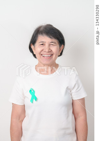 Elderly with Teal Ribbon for September Ovarian Cancer Awareness month, PCOS, January Cervical Cancer, April Sexual Assault, June PSTD, Post Traumatic Stress Disorder, May Tourette syndrome Elderly with Teal Ribbon for September Ovarian Cancer Awareness month, PCOS, January Cervical Cancer, April Sexual Assault, June PSTD, Post Traumatic Stress Disorder, May Tourette syndrome 134330298