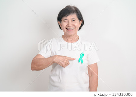 Elderly with Teal Ribbon for September Ovarian Cancer Awareness month, PCOS, January Cervical Cancer, April Sexual Assault, June PSTD, Post Traumatic Stress Disorder, May Tourette syndrome Elderly with Teal Ribbon for September Ovarian Cancer Awareness month, PCOS, January Cervical Cancer, April Sexual Assault, June PSTD, Post Traumatic Stress Disorder, May Tourette syndrome 134330300
