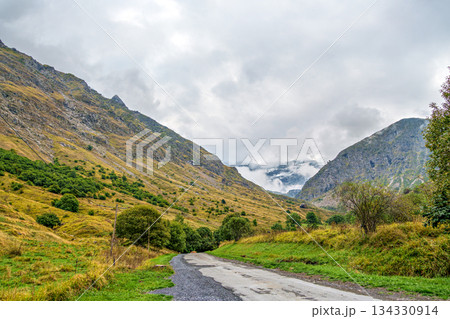 Hiking trail in Cirque de Troumouse at Heas in the Hautes-Pyrenees department in France, forming the border with Spain 134330914