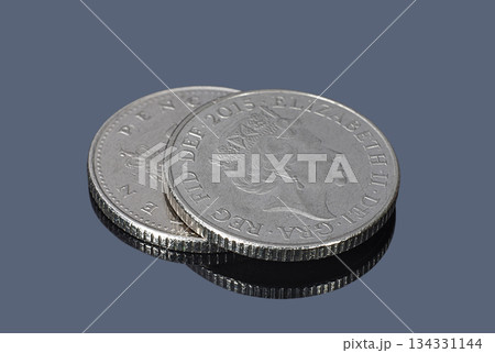 British ten pence coins on a dark background British ten pence coins on a dark background 134331144