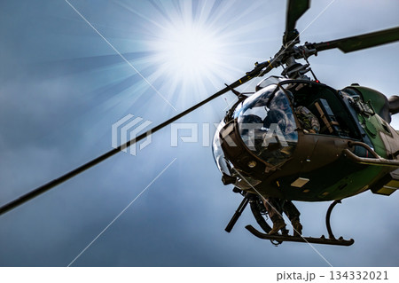 Silhouette of a combat helicopter in the sky, gazelle seen from underneath, air transportation Silhouette of a combat helicopter in the sky, gazelle seen from underneath, air transportation 134332021