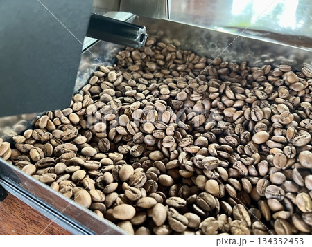 Coffee beans in a roasting machine at a coffee shop Coffee beans in a roasting machine at a coffee shop 134332453