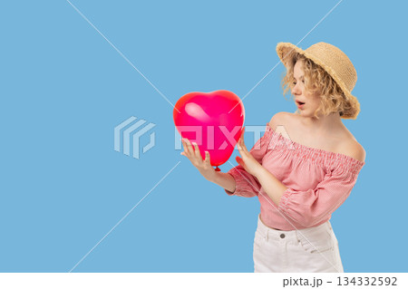Valentine's Day features a girl surprised by a heart balloon Valentine's Day features a girl surprised by a heart balloon 134332592