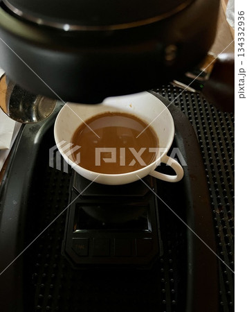 Coffee maker making coffee with espresso coffee machine in the coffee shop. Coffee maker making coffee with espresso coffee machine in the coffee shop. 134332936