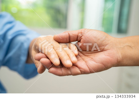 Caregiver holding hands Asian elderly woman patient, help and care in hospital. Caregiver holding hands Asian elderly woman patient, help and care in hospital. 134333934