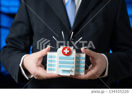 The hospital building is in the hands of a businessman. Patron. Private support for healthcare, sponsorship and social responsibility. Philanthropy, healthcare funding and public private partnership. 134335220