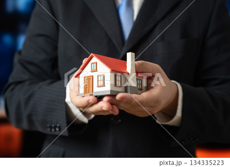 A home in the hands of a businessman. Real estate investments and development. Property ownership, housing projects and asset growth. Real estate marketing, investment strategy and urban development. 134335223