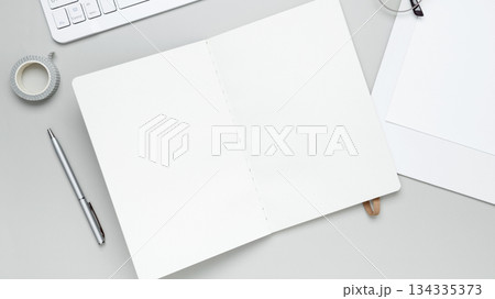 Tidy workspace with notebook, keyboard, glasses, and stationery fostering productivity Tidy workspace with notebook, keyboard, glasses, and stationery fostering productivity 134335373