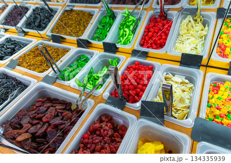 A counter at a healthy food store. Lots of dried fruits and candies made from caramelized and candied fruit A counter at a healthy food store. Lots of dried fruits and candies made from caramelized and candied fruit 134335939