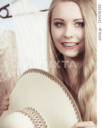 Woman in shop or wardrobe picking clothes Woman in shop or wardrobe picking clothes 134336160