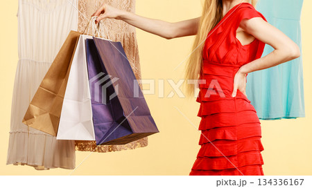 Woman in shop picking summer outfit 134336167