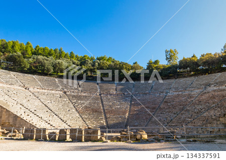 Ancient Theatre of Epidaurus is theatre in Greek city of Epidaurus, located on southeast end of sanctuary dedicated to the ancient Greek God of medicine, Asclepius in Peloponnese, Greece 134337591