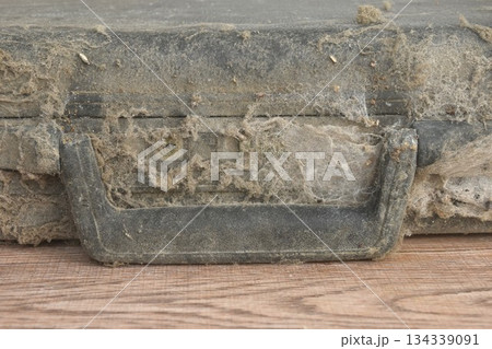 dust and dirty old black briefcase lock by coding number on table 134339091