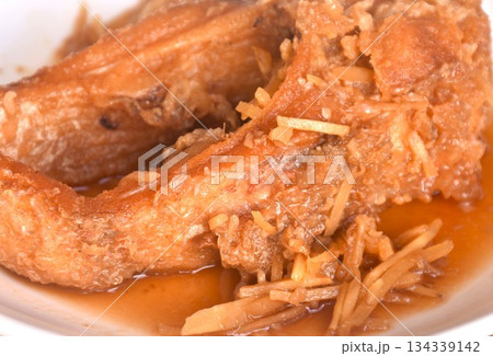 deep fried chop red Tilapia or mango fish slice dressing soy sauce and celery on plate  134339142
