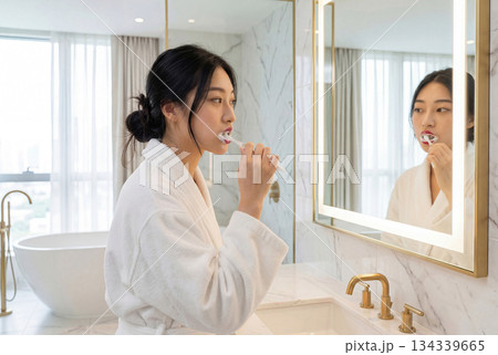 Young asian woman brushing teeth in modern bathroom. AI-generated item 134339665