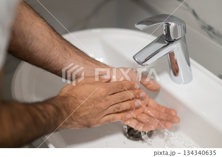Close up picture of a man washing his hands 134340635