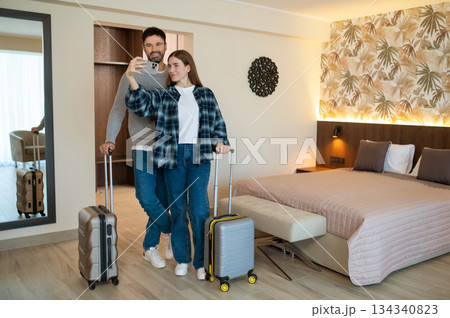 Happy couple making selfie in a hotel room after arrival 134340823