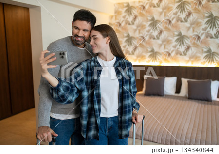 Happy couple making selfie in a hotel room after arrival 134340844