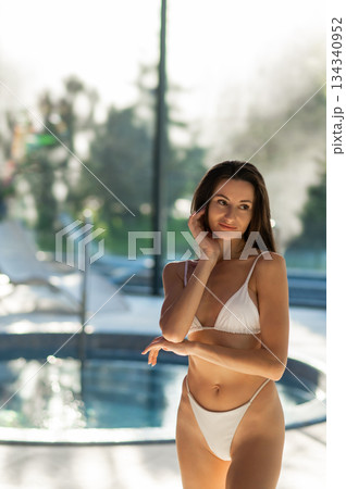 Cute slim beautiful young woman in white bikini in spa center 134340952