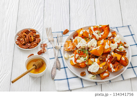 baked butternut squash with cheese, thyme, pecan 134341756