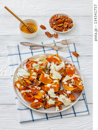 baked butternut squash with cheese, thyme, pecan 134341757