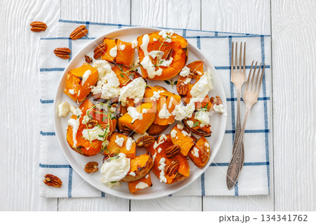 baked butternut squash with cheese, thyme, pecan baked butternut squash with cheese, thyme, pecan 134341762