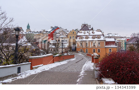 Buildings and pathways in a snowy cityscape during winter in Lublin 134343399