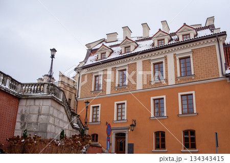 Historic building with snow on the roof in a city square during winter Historic building with snow on the roof in a city square during winter 134343415