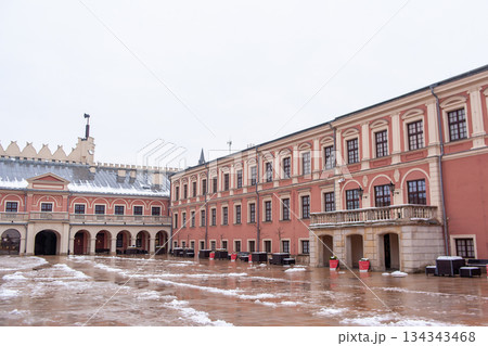 Historic courtyard of Lublin castle in winter with snow on buildings and ground 134343468