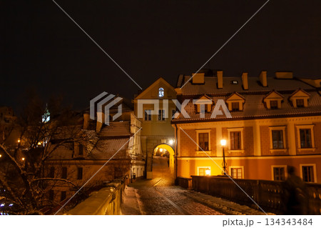 Night scene of a street with buildings and a bridge in a city Lublin 134343484