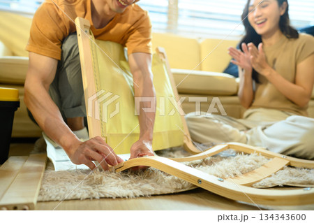 Photo series of young asian couple assembly a new furniture at home Photo series of young asian couple assembly a new furniture at home 134343600