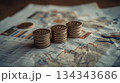 Stacks of coins lie on charts displaying statistics and analytics. Financial reporting and accounting. 134343686