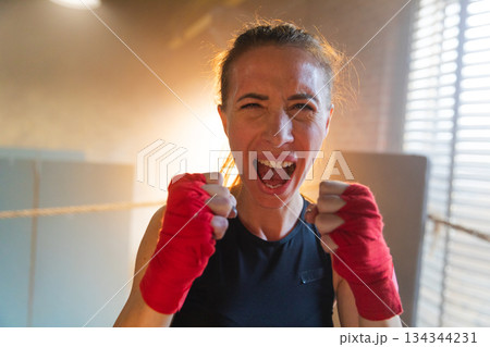 Outcry independent girl power. Angry strong crazy woman fighter screaming looking aggressive on boxing ring. Powerful ambitious victorious confident successful girl champion emotional energetic Outcry independent girl power. Angry strong crazy woman fighter screaming looking aggressive on boxing ring. Powerful ambitious victorious confident successful girl champion emotional energetic 134344231