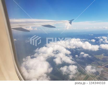 Airplane wing over clouds window view horizontal 134344310