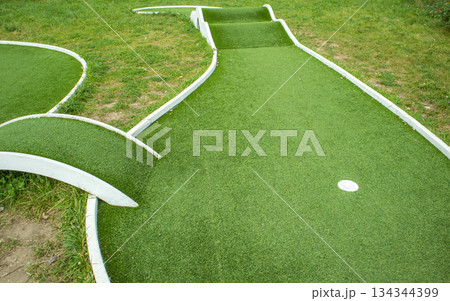 Mini golf lane with artificial turf and hole horizontal Mini golf lane with artificial turf and hole horizontal 134344399