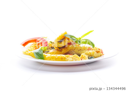Fried eggs for breakfast with vegetables and herbs, isolated on white 134344496