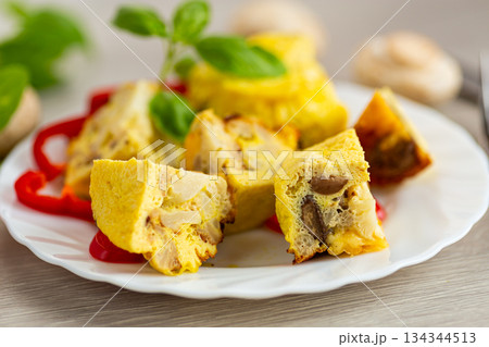 Delicious golden omelet with mushrooms and cauliflower pieces Delicious golden omelet with mushrooms and cauliflower pieces 134344513