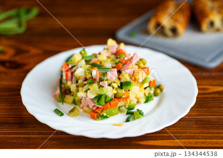 Classic olivier salad served fresh on white plate Classic olivier salad served fresh on white plate 134344538