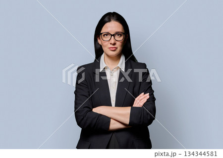 Confident successful middle-aged businesswoman in black jacket on light studio background Confident successful middle-aged businesswoman in black jacket on light studio background 134344581