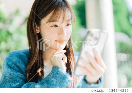 テラスでスマホを見る女性 テラスでスマホを見る女性 134344833