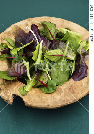 Fresh salad in a rustic wooden bowl. 134346854
