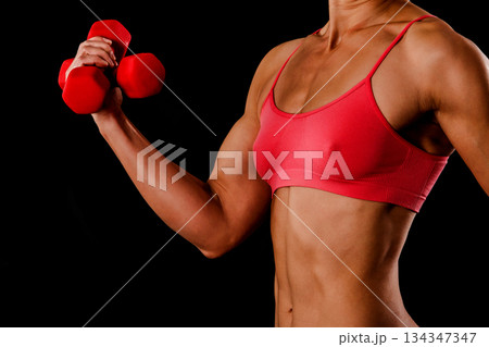 Fitness woman with barbells on black background 134347347