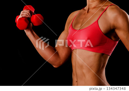 Fitness woman with barbells on black background Fitness woman with barbells on black background 134347348